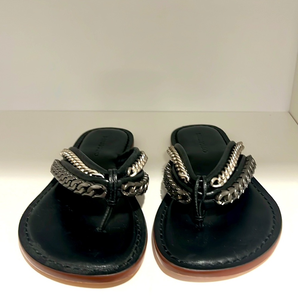 Black leather flip flops with chain details